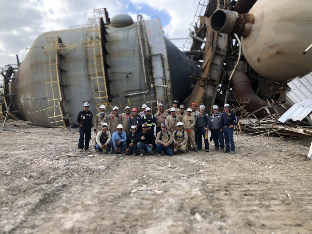 Midwest Steel team takes group photo in front of 800-Ton Structure Demolition